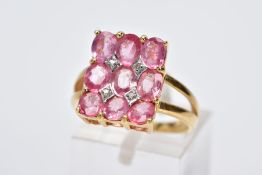 AN 18CT GOLD RING, designed with a rectangular panel set with nine claw set oval cut pink stones