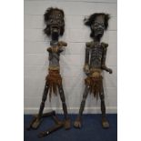 A PAIR OF MALE AND FEMALE STANDING LIFESIZE TRIBAL FIGURES, with spears largest height 207cm (both