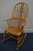 A BEECH SPINDLE HOOP BACK WINDSOR ROCKING CHAIR (sd to front left leg)