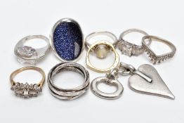 EIGHT WHITE METAL RINGS AND A PENDANT, eight rings of various designs such as a large oval blue