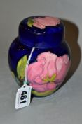 A MOORCROFT GINGER JAR AND COVER, dark blue ground with pink magnolia, impressed marks, height 11cm