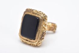 A 9CT GOLD FOB, decorative scroll handle set with a rectangular onyx base, hallmarked 9ct gold