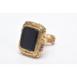 A 9CT GOLD FOB, decorative scroll handle set with a rectangular onyx base, hallmarked 9ct gold