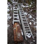AN ALUMINIUM EXTENSION LADDER with 13 rungs to each 3.5m section, a step ladder and a bundle of 7