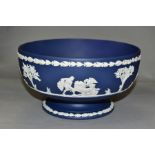 A WEDGWOOD DARK BLUE JASPERWARE PEDESTAL FRUIT BOWL, the applied decoration of classical figures