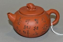 A 20TH CENTURY CHINESE STONEWARE TEA POT OF CIRCULAR FORM, the cover with beast finial, impressed