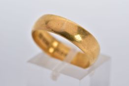 A 22CT GOLD WIDE BAND, of a plain polished design hallmarked 22ct gold London, ring size P½,