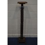 AN EARLY 20TH CENTURY OAK DOUBLE BARLEY TWIST TORCHERE STAND, on a stepped base and four scrolled