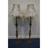 A PAIR OF EARLY 20TH CENTURY HEAVY BRASS STANDARD LAMPS, with a fabric shade, height to fitting