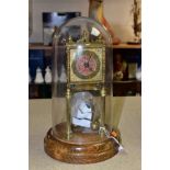 A MID 20TH CENTURY BRASS ANNIVERSARY CLOCK, pendulum loose, mounted on a circular oak base and