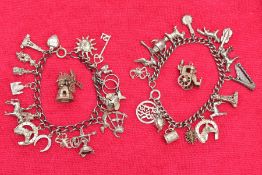 TWO WHITE METAL CHARM BRACELETS AND TWO CHARMS, the first bracelet suspending seventeen charms in