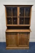 AN EARLY 20TH CENTURY LIGHT OAK CUPBOARD, double glazed cupboard top above double sliding doors,