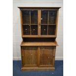 AN EARLY 20TH CENTURY LIGHT OAK CUPBOARD, double glazed cupboard top above double sliding doors,