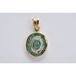 A 9CT GOLD EMERALD AND DIAMOND PENDANT, of an oval form set with a central oval cut emerald within a