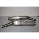 TWO APRILLA ZD41061 MOTORBIKE EXHAUST BACK BOXES appear to be unused or have had very little use