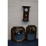 A MAHOGANY WALL CLOCK (sd) together with an early 20th century oak framed bevelled edge wall mirror,