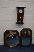 A MAHOGANY WALL CLOCK (sd) together with an early 20th century oak framed bevelled edge wall mirror,