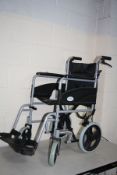 A SIMPLELIFE MOBILITY FOLDING WHEEL CHAIR with two footrests