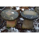 TWO COMPOSITE STADDLE STONES with tops 48cm high (2)