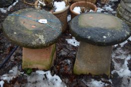 TWO COMPOSITE STADDLE STONES with tops 48cm high (2)