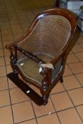 A LATE 19TH CENTURY MAHOGANY CHILDS ARM CHAIR, with Bergere seat and back, removable foot rest, (