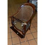 A LATE 19TH CENTURY MAHOGANY CHILDS ARM CHAIR, with Bergere seat and back, removable foot rest, (