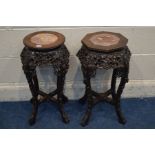 TWO ORIENTAL ROSEWOOD TORCHERE STANDS, with red veined marble inserts, one circular and one