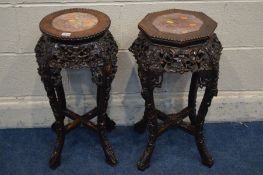 TWO ORIENTAL ROSEWOOD TORCHERE STANDS, with red veined marble inserts, one circular and one