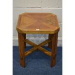 A MULTIWOOD SQUARE OCCASIONAL TABLE canted corners on a cross stretchered base 50cm squared x height