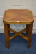 A MULTIWOOD SQUARE OCCASIONAL TABLE canted corners on a cross stretchered base 50cm squared x height