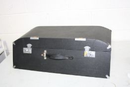 A SHAPED SMALL CAR SUITCASE with angled front and back and a partially domed top, handle and two