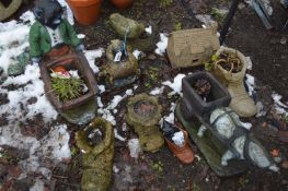 EIGHT COMPOSITE GARDEN FIGURES including a cat pushing a barrow 58cm high, a horse and cart, three