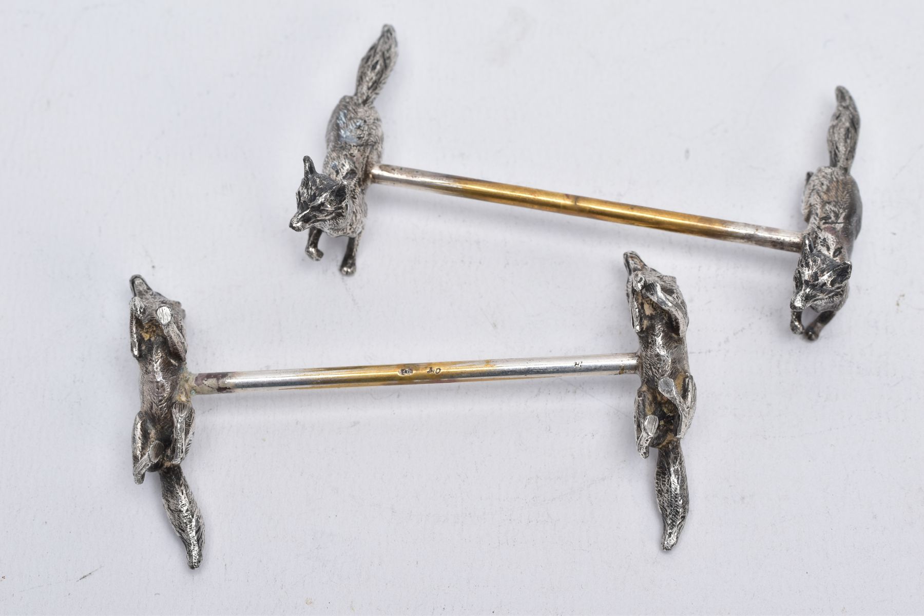 A PAIR OF WHITE METAL KNIFE RESTS, each rest modelled with two foxes to each end with a worn gilt - Image 4 of 5