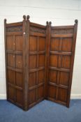 A REPRODUCTION OAK PANELLED THREE FOLD FLOOR STANDING SCREEN, each panel width 69cm x overall