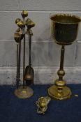 A BRASS FOUR PIECE COMPANION SET with ball and claw detail on a matching stand, together with a