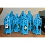 A SET OF SEVEN TURQUOISE PAINTED TEA LIGHT HOLDERS, of Middle Eastern lantern style, three height