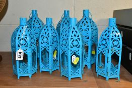 A SET OF SEVEN TURQUOISE PAINTED TEA LIGHT HOLDERS, of Middle Eastern lantern style, three height