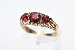 A LATE 20TH CENTURY 9CT GOLD, THREE STONE GARNET RING, designed with three graduated circular cut