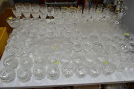 A MATCHED SUITE OF CUT GLASS DRINKING GLASSES, together with a pair of conical shaped decanters,