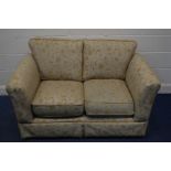 A FLORAL AND GOLD UPHOLSTERED TWO SEATER SETTEE, width 142cm