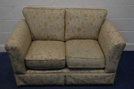 A FLORAL AND GOLD UPHOLSTERED TWO SEATER SETTEE, width 142cm