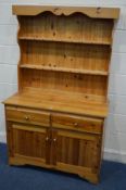 A MODERN PINE DRESSER with two drawers, width 106cm x depth 45cm x height 171cm