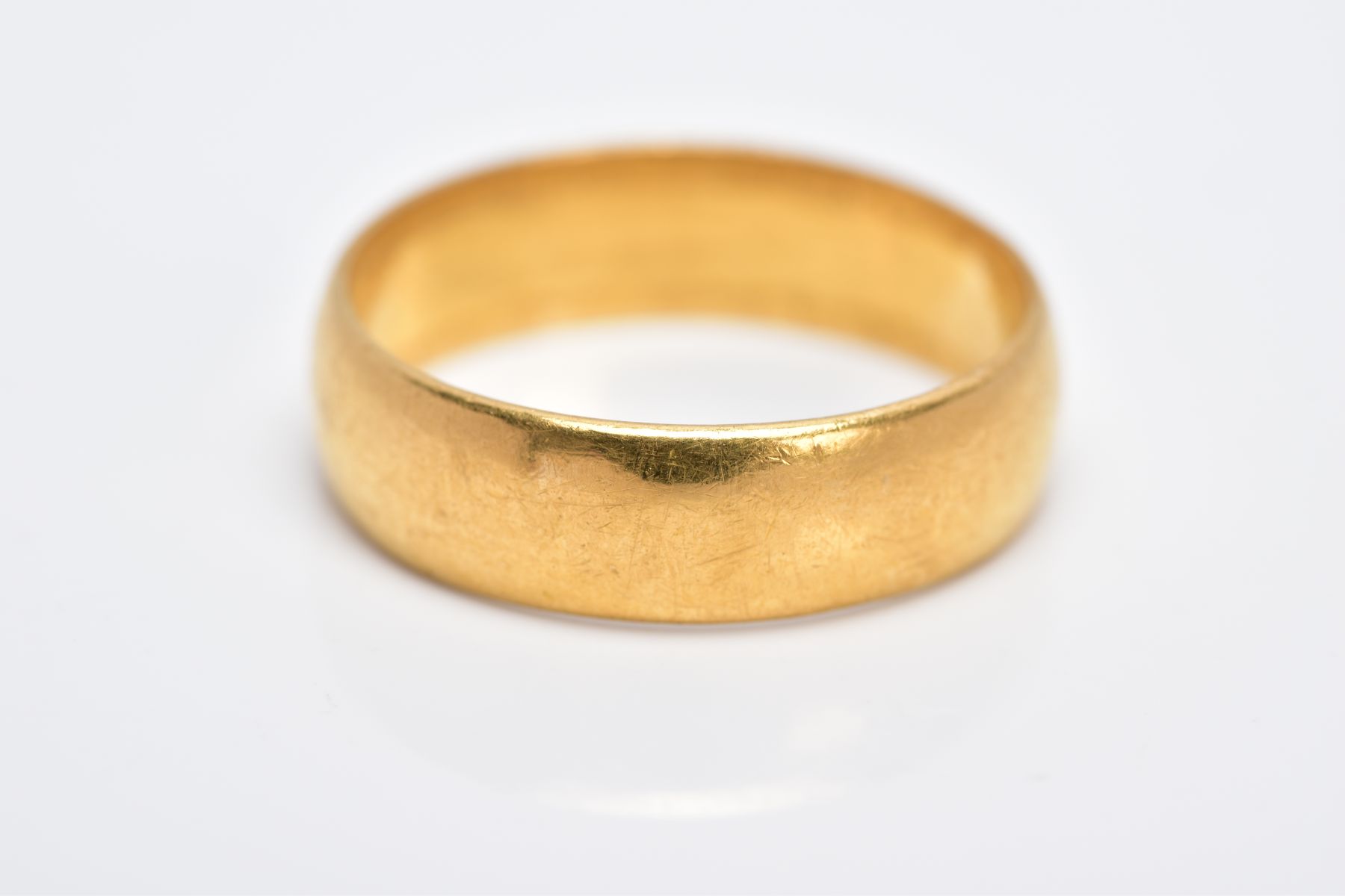 A 22CT GOLD WIDE BAND, of a plain polished design hallmarked 22ct gold London, ring size P½, - Image 2 of 2