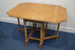 A GOLDEN OAK BARLEY TWIST GATE LEG TABLE