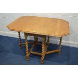 A GOLDEN OAK BARLEY TWIST GATE LEG TABLE