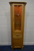 A MORRIS FURNITURE COMPANY, RANGE HORIZON, LIGHT OAK GLAZED SINGLE DOOR CORNER CUPBOARD, above a