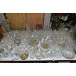A QUANTITY OF GLASSWARE, including drinking glasses, bowls, jugs, decanters, rose bowls, vases,