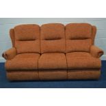 A TANGERINE UPHOLSTERED THREE SEATER SETTEE (splits into three sections)