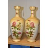 A PAIR OF WILTSHAW & ROBINSON (LTD) CARLTON WORKS IVORY GROUND BALUSTER VASES, printed and painted