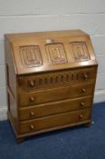 AN OAK JAYCEE LINENFOLD BUREAU, with three drawers, width 76cm x depth 42cm x height 92cm (one